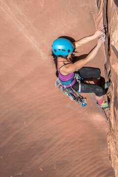 Profile view of woman climbing rock, Utah, USA