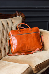 close-up photo of orange leather bag corporate.