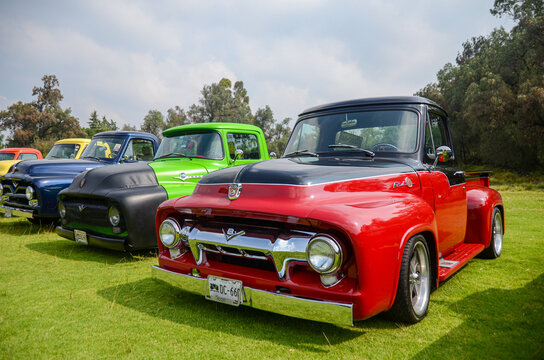 Mexico - September 2018: A classic and retro Ford pickup in a vintage vehicle event. Red antique Ford truck parked in a row with other classic cars on a show. Automobile exhibition outdoors.