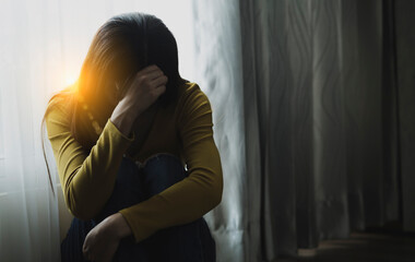 Sad young woman sitting in the bedroom, People with depression concept.	