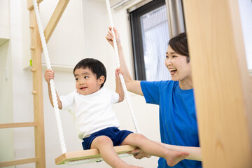 Fototapeta premium Toddlers enjoying swings at daycare centers and sports clubs.