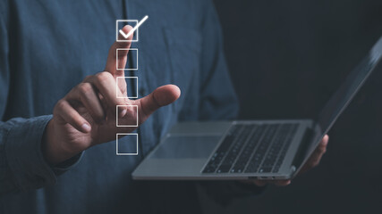 Businessman working with laptop. Checking mark up on the check boxes. Successful completion of business tasks. Digital marketing of statistics level up of graph. Business management goal strategy.