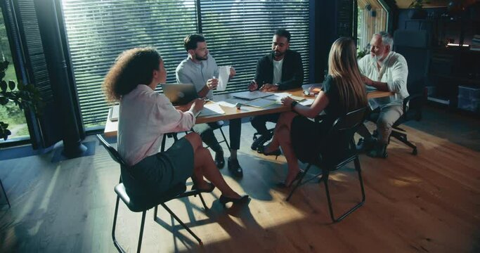 Finance business stakeholders, team of investors work together discussing documents at office table meeting slow motion.