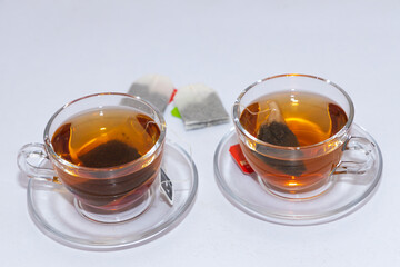 Isolated image of two cups of leaf herbal tea with white background and copy space