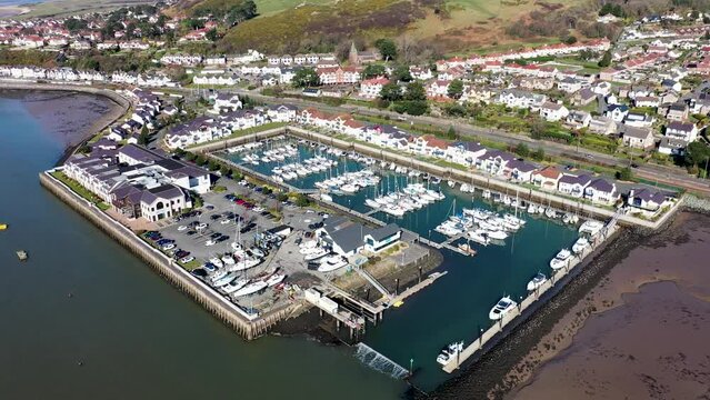 Aerial footage of the town of Deganwy in Conwy County Borough in Wales It lies in the Creuddyn Peninsula alongside Llandudno Rhos-on-Sea showing the Deganwy Marina and railway along the Conwy river