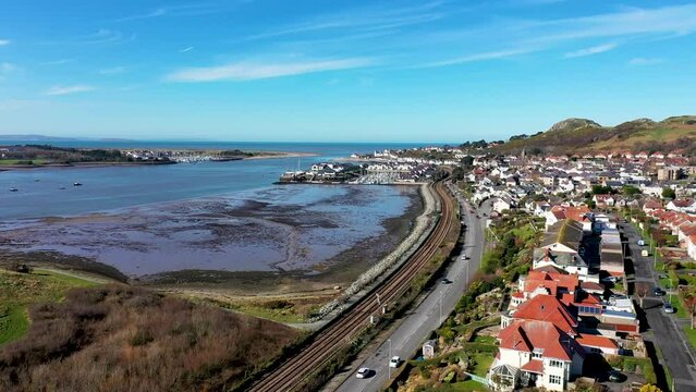 Aerial footage of the town of Deganwy in Conwy County Borough in Wales It lies in the Creuddyn Peninsula alongside Llandudno Rhos-on-Sea showing the Deganwy Marina and railway along the Conwy river