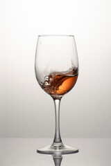 Splash of rose wine in glass, frozen motion
