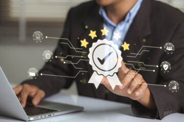 Businessman working on labtop with check mark symbol, golden five stars and standard quality control. The concept of international ISO service, standards and quality assurance is certified