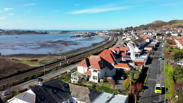 Aerial footage of the town of Deganwy in Conwy County Borough in Wales It lies in the Creuddyn Peninsula alongside Llandudno Rhos-on-Sea showing the Deganwy Marina and railway along the Conwy river