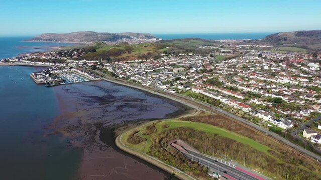 Aerial footage of the town of Deganwy in Conwy County Borough in Wales It lies in the Creuddyn Peninsula alongside Llandudno Rhos-on-Sea showing the A55 North Wales Expressway along the Conwy river