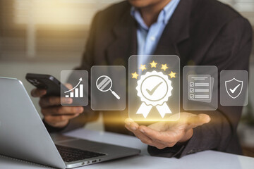 Businessman working on labtop with check mark symbol, golden five stars and standard quality...