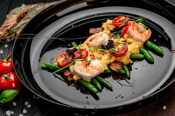 Omelet with shrimp, caviar and grilled tomatoes on a bed of green beans and bacon