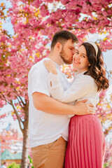 Fototapeta premium couple lovers under blooming sakura tree
