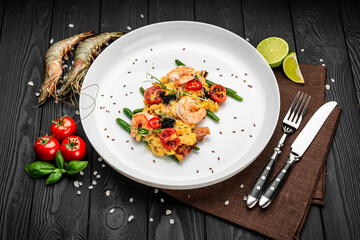 Omelet with shrimp, caviar and grilled tomatoes on a bed of green beans and bacon