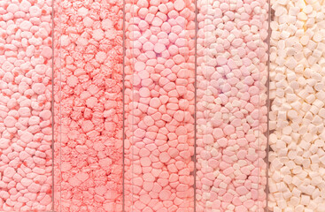 Lot of Pastel pink marshmallows in a shop window. Food texture.