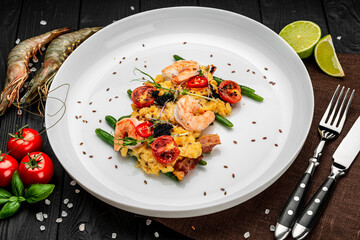 Omelet with shrimp, caviar and grilled tomatoes on a bed of green beans and bacon