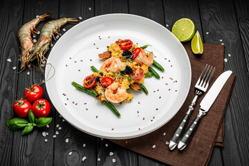 Omelet with shrimp, caviar and grilled tomatoes on a bed of green beans and bacon