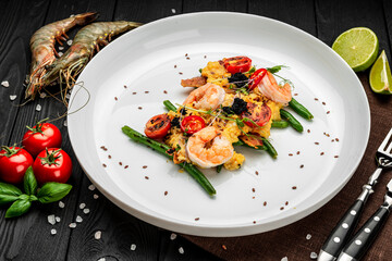 Omelet with shrimp, caviar and grilled tomatoes on a bed of green beans and bacon