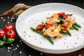 Omelet with shrimp, caviar and grilled tomatoes on a bed of green beans and bacon