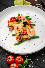 Omelet with shrimp, caviar and grilled tomatoes on a bed of green beans and bacon