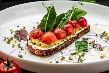 Delicious bruschetta with cream cheese, gluacomoli sauce and cherry tomatoes