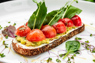 Delicious bruschetta with cream cheese, gluacomoli sauce and cherry tomatoes