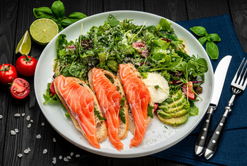 Salted salmon on croutons with fresh salad and cream cheese