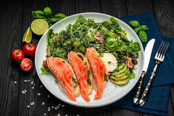 Salted salmon on croutons with fresh salad and cream cheese