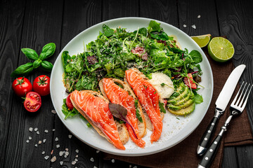 Salted salmon on croutons with fresh salad and parmesan cheese