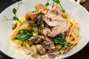 Plate of chicken pasta on a rustic wooden table