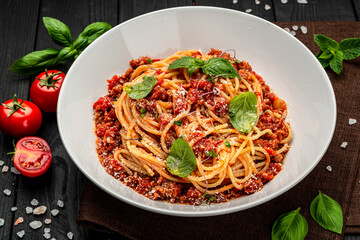 Traditional italian spaghetti bolognese on a dark background