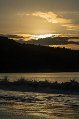 Sunset behind the hills at the beach of the Seychelles.