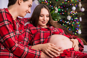 A close-up of the pregnant belly on which the mother-to-be placed her hands.