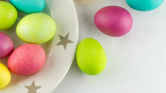 4K view of colorful Easter eggs on a plate with stars close-up