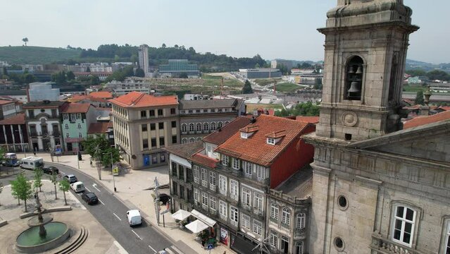 Drone flying over San Peter Church and Toural Square - main square in downtown of ancient city Guimaraes, North of Portugal 