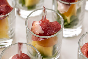 Appetizer on a skewer roll with dried meat