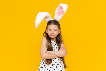 A frustrated girl with the Easter bunny's masquerade ears on, a disgruntled girl is angry that she...