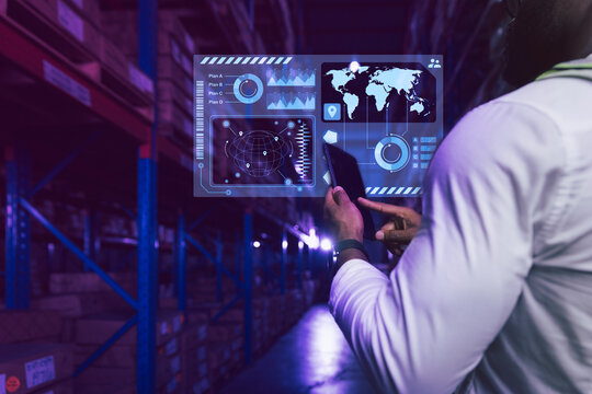 Futuristic smart warehouse and logistics concept, Warehouse staff working on data seeking with hologram virtual interface searching panel 