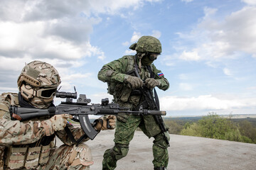 Military soldiers shoot opponents in the rooftop war