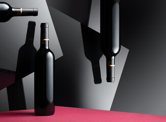 Bottles of red wine with a reflection on the glossy black surface.