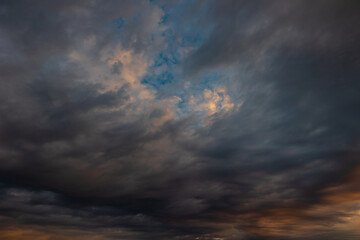 Cloudscape background. Dramatic clouds at sunrise or sunset