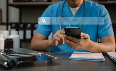 Medical Technology Concepts. Medical students use mobile phones to search for information in a modern office in the morning at the desk.