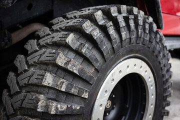 Close up of an off-road tire. Black wheel of an off-road vehicle