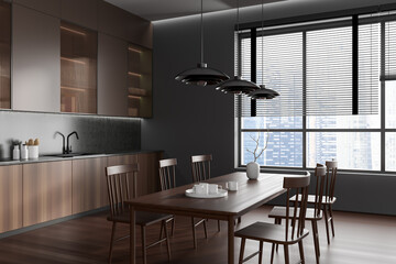 Corner view on dark kitchen room interior with dining table