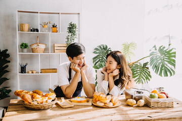 In Kitchen: Perfectly Happy Couple Preparing Healthy Food, Lots of Vegetables. Man Juggles with Fruits, Makes Her Girlfriend Laugh. Lovely People in Love Have Fun