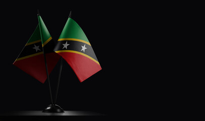 Small national flags of the Saint Kitts and Nevis on a black background