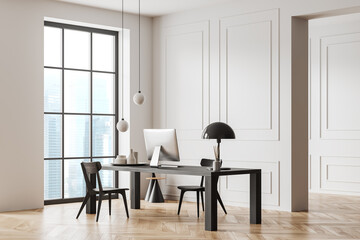 Light business interior with desk and pc computer, panoramic window
