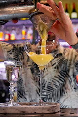 man hand bartender making cocktail in glass on the bar counter