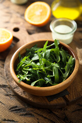 Fresh arugula in a wooden bowl