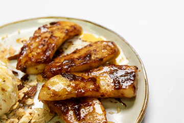 Pan-fried cinnamon bananas with ice-cream and crushed nut on top.